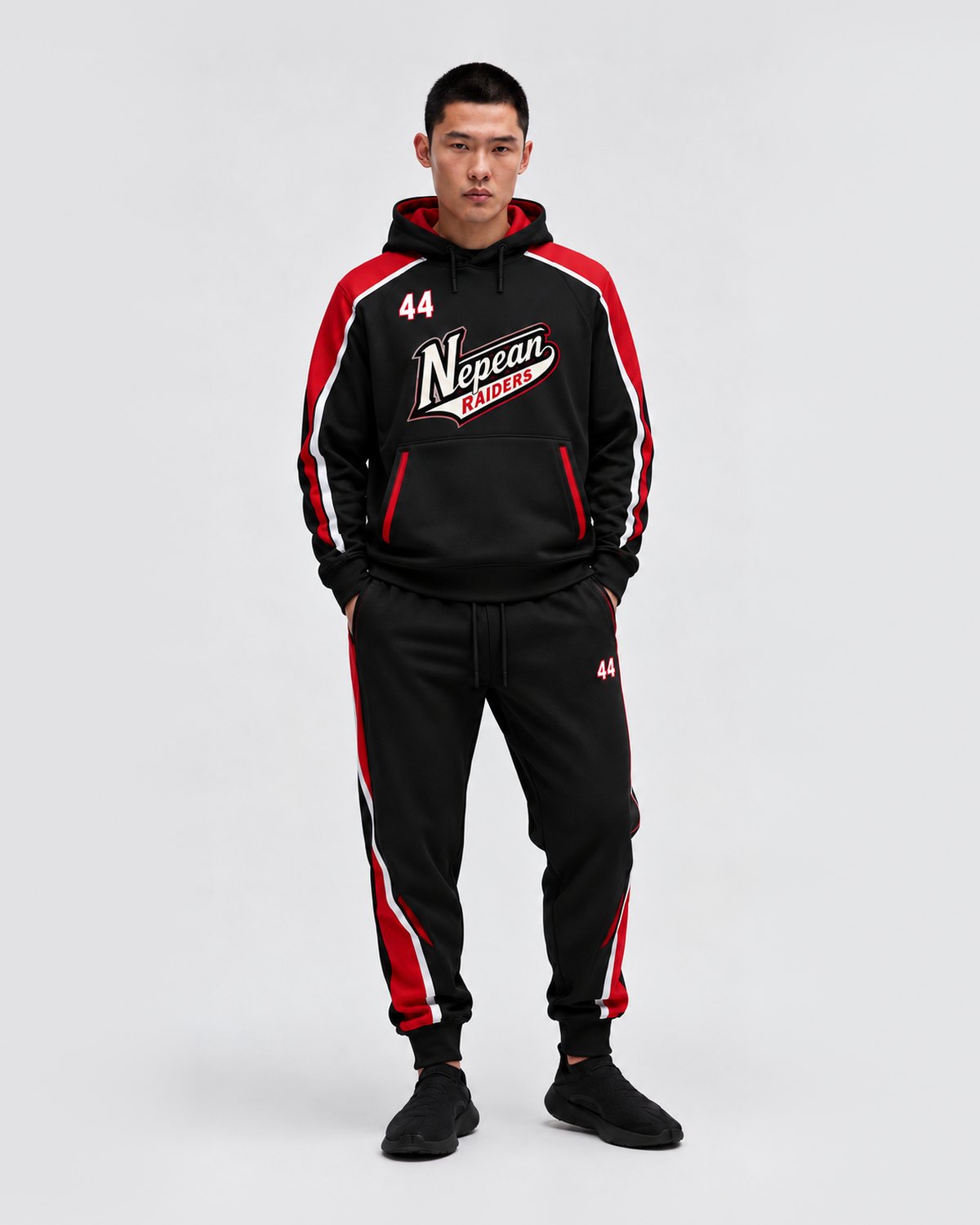 Custom black team hoodie and sweatpant set with red and white trim by Suit Up Tailors